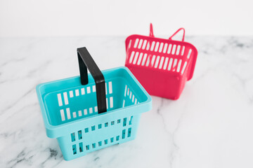 couple of shopping baskets with different shapes and color for different brand or stores, competition and retail industry