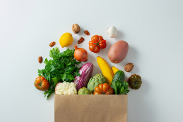 Wall Mural - Healthy food background. Healthy vegan vegetarian food in paper bag vegetables and fruits on white, copy space. Shopping food supermarket and clean vegan eating concept