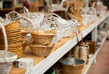 Wall Mural - Variety of wicker baskets on shelves in home decor store