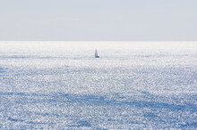 Lonely Sailboat In The Sea With Wave Light