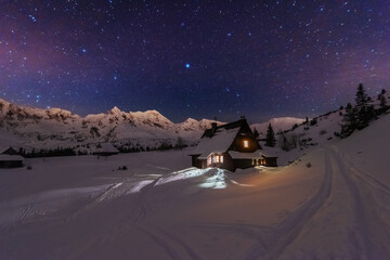 Wall Mural - night winter landscapes in the high tatras, with mountain houses on a background of snow-capped moun