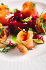 Wall Mural - Cured Salmon Gravlax with Beet and Berries. Salted fish fillet with beetroot and dill in white plate on table. Gourmet, swedish, scandinavian seafood concept.