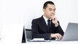 © Puwasit Inyavileart - Young Asian office worker presses he finger on a laptop keyboard to analyze financial data and summarize her work in a private office, Office workers, handsome male employee in a black suit.
