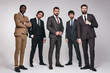 © Roman - sexy handsome fashion businessmen models dressed in elegant classic suit posing on gray wall indoors. people, business, style, fashion concept