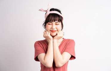 Wall Mural - Young Asian woman posing on white background