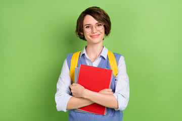 Sticker - Photo portrait of cheerful student in spectacles keeping book pile preparing for test isolated vivid green color background