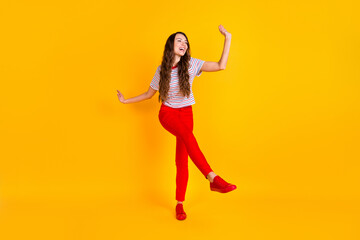 Sticker - Full size photo of young excited girl happy positive smile have fun dance look empty space isolated over yellow color background