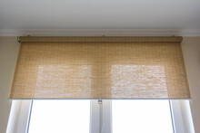 Roller Blinds Made Of Thin Bamboo On The Window