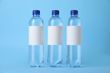 Wall Mural - Plastic bottles with soda water on light blue background