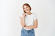 © Cookie Studio - Portrait of happy natural girl, smiling and laughing with joy, looking at camera carefree, standing in casual clothes against white background