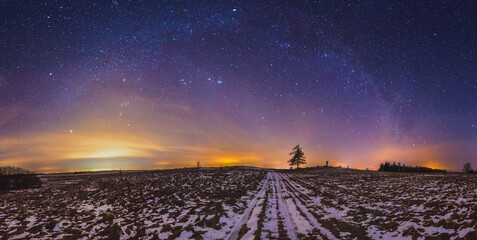 Wall Mural - Milky way galaxy, night sky panorama with stars and snow on foreground
