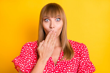 Canvas Print - Photo of shocked guilty young woman hold hand mouth afraid tell speak secret isolated on yellow color background