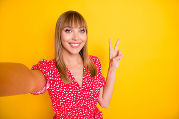 Sticker - Photo of sweet shiny young lady wear red clothes tacking selfie showing v-sign isolated yellow color background