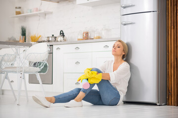 Wall Mural - Blonde housewife in protective gloves feeling tired