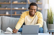 © Prostock-studio - Positive black guy attending online training from home