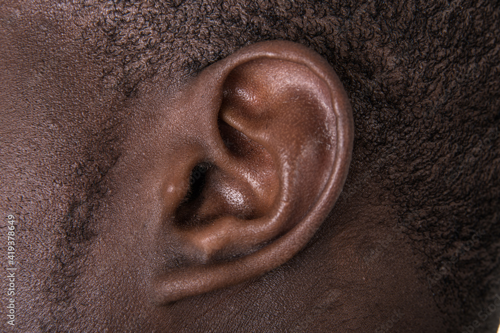 Black man ear close up. African american ear lobe. Hear and listen concept. - obrazy, fototapety, plakaty 