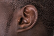 Black man ear close up. African american ear lobe. Hear and listen concept.