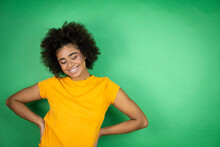 African American Woman Wearing Orange Casual Shirt Over Green Background With A Happy Face Standing And Smiling With A Confident Smile Showing Teeth