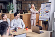 © Roman - Successful business team listen a woman which conducting presentation in the board room