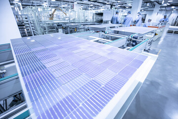 Solar panel manufacturing workshop, workers operate modern CNC machine tools. 4.0 in industry. Smart factory.