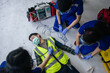 © ME Image - Team work medical emergency use Automated External Defibrillator (AED) being operated on during help unconscious worker accident in construction site.