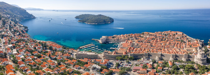 Wall Mural - Aerial panorama drone shot of Dubrovink city old town port with view of Lokrum island in Croatia summer morning