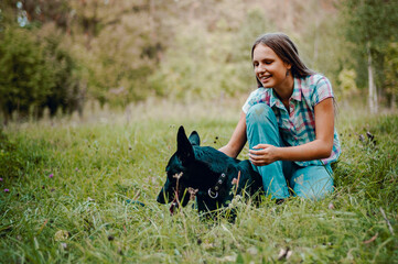 young teenage girl with a shepherd dog in the park outdoor