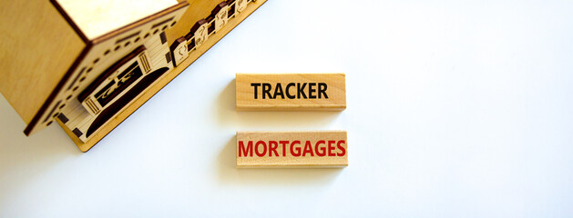 Tracker mortgage symbol. Concept words 'Tracker mortgage' on wooden blocks on a beautiful white backgrounds. Wooden model of house. Business, tracker mortgage concept.