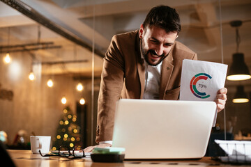 Wall Mural - Young businessman working on laptop in his office. Handsome man having video call..