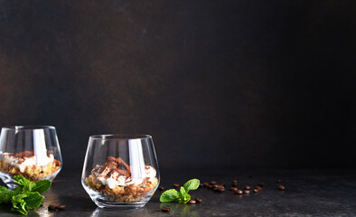 Wall Mural - Dessert tiramisu in a glass on a dark concrete background.