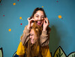 © Albert Morcillo/ADDICTIVE STOCK - Positive female playing with hair while having fun with friend against colorful wall