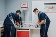 © Alberto Ortega/ADDICTIVE STOCK - Unrecognizable male veterinarians in uniforms and respiratory masks curing animal patient lying on table in hospital