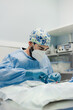 © Alberto Ortega/ADDICTIVE STOCK - Focused male veterinarian in uniform and respiratory mask using medical instruments during surgery in hospital