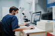 © Alberto Ortega/ADDICTIVE STOCK - Back view of unrecognizable focused male veterinarian in uniform watching X ray illustration on desktop computer in laboratory