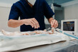 © Alberto Ortega/ADDICTIVE STOCK - Focused male veterinarian in uniform and respiratory mask using medical instruments during surgery in hospital