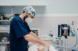 © Alberto Ortega/ADDICTIVE STOCK - Focused male veterinarian in uniform and respiratory mask using medical instruments during surgery in hospital