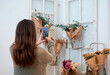 © Daniel De Andres/ADDICTIVE STOCK - Back view of unrecognizable female taking photo of flowers wrapped in paper selling in bulk store with eco friendly products
