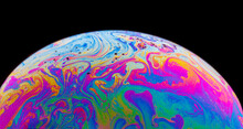 Panoramic View Of Closeup Bubble Textured Backdrop Representing Colorful Planet With Wavy Lines On Round Shaped Surface On Black Background