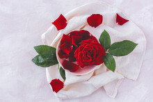 Top View Composition Of Blooming Fresh Red Rose Flowers Arranged On White Cloth With Blank Space