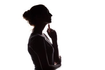 Wall Mural - profile silhouette of pensive girl with hand at the chin, a young woman with hand-picked hair on a white isolated background