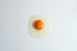 © Fatima Guisado/ADDICTIVE STOCK - Top view of fresh raw chicken egg placed on white background in bright studio