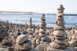 © Francisco Carrodeguas/ADDICTIVE STOCK - Picturesque scenery of zen stone pyramids created in beach near waving ocean on sunny day in Vila Nova de Milfontes, portugal