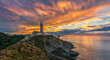© Ivan Ferrero/ADDICTIVE STOCK - Scenic view of small island with lighthouse called Faro de Cabo Mayor connected with coastline by bridge under dramatic cloudy sky at sunset time in Santander in Spain