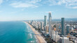 © Jordi Bataller/ADDICTIVE STOCK - Breathtaking aerial view of modern skyscrapers located near famous sandy Surfers Paradise Beach washing by powerful ocean in Queensland