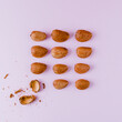 © Jose Lax/ADDICTIVE STOCK - Top view of whole crispy oval shaped nuts near halves of shell representing uniqueness and chaotic concepts
