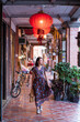 © Juan Alberto Ruiz/ADDICTIVE STOCK - Young Asian female in long dress walking along historic Daxi Old Street and looking away while enjoying vacation in Taiwan