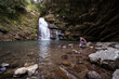 © Juan Alberto Ruiz/ADDICTIVE STOCK - Side view of female tourist sitting on rock near Tiemu Falls in forest in Taiwan