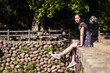 © Juan Alberto Ruiz/ADDICTIVE STOCK - Side view of Asian female in dress sitting on old Daping Red Bridge and enjoying summer vacation in Taiwan