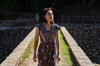 © Juan Alberto Ruiz/ADDICTIVE STOCK - Female in maxi dress standing on Daping Red Bridge during vacation in Taiwan in summer