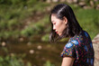 © Juan Alberto Ruiz/ADDICTIVE STOCK - Side view of tranquil Asian female standing in nature in Taiwan on sunny day in summer and looking down